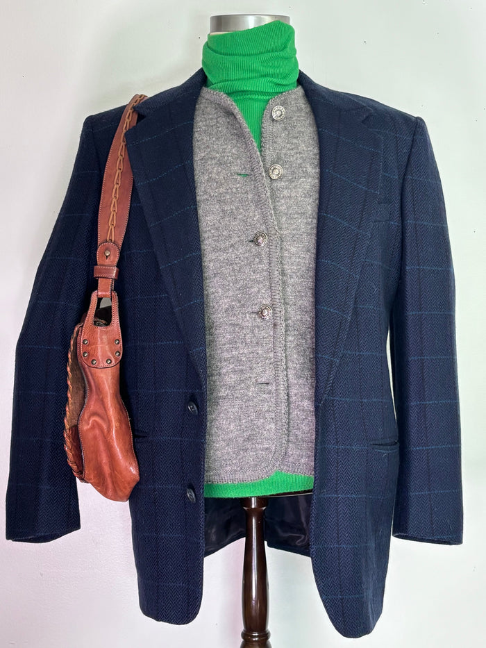 Grey wool cardigan styled with green turtleneck and navy windowpane blazer