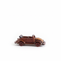 Vintage hand-carved wooden VW Beetle convertible model in mahogany on white background