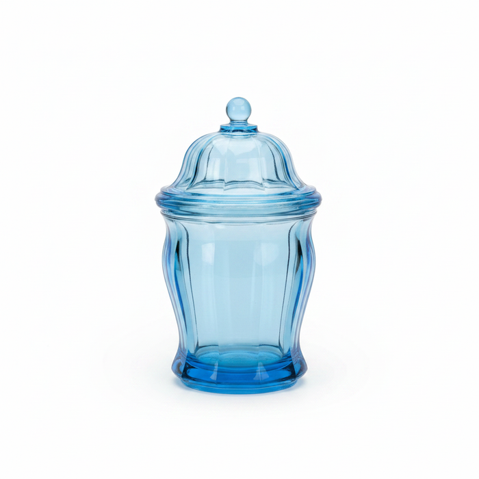 Vintage ice blue pressed glass lidded canister on white background