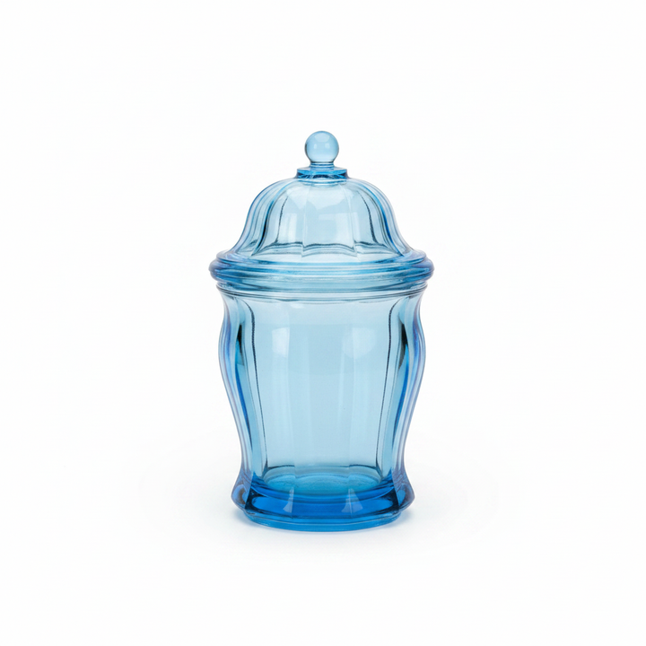 Vintage ice blue pressed glass lidded canister on white background