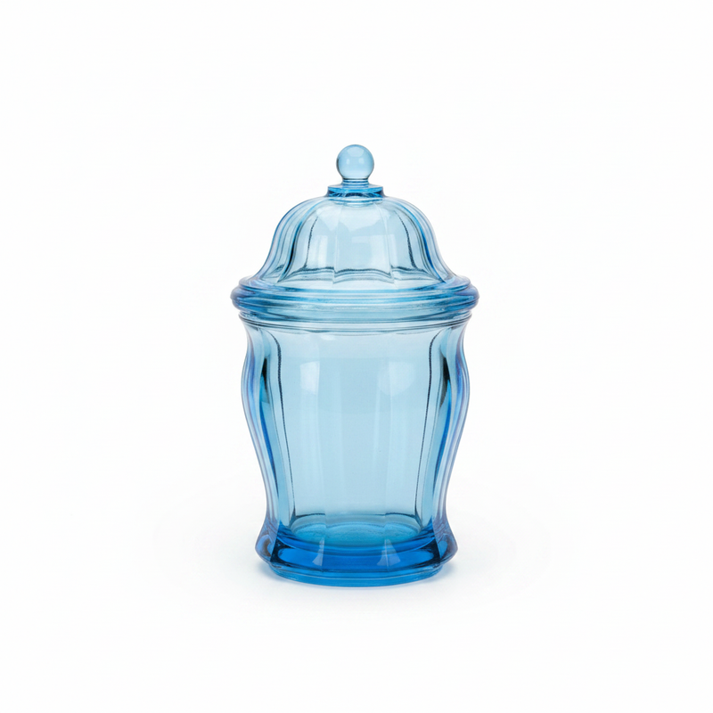 Vintage ice blue pressed glass lidded canister on white background